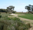 The par 5 11th at Long Point at Amelia Island Plantation curves left around a marsh and ends with a green framed by oak trees.