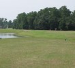 The Champions Club at Julington Creek's par-5 14th hole starts as a dogleg left along water, then requires a right turn to get to the green.