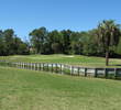 The par-5 14th hole at Selva Marina Country Club concludes with an offset water hazard that requires you to match length and location.