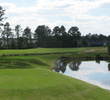 The par-5 16th hole at The Golf Club at Fleming Island is a sharp dogleg right over a pond and marsh, with bunkers scattered all over the fairway.