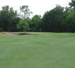 The eighth hole at Bent Creek Golf Course has a well guarded green, with a tree and bunker left and a drop-off into the woods right.