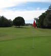 A tree dominates the center of the 13th fairway, as seen from the green, at the Country Club of Orange Park.