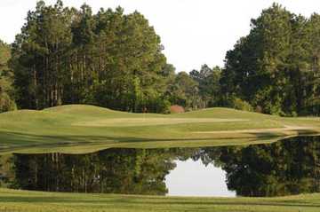 A view over water of green at St. Johns Golf Club