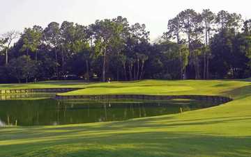 A view of green with water in foreground at San Jose Country Club